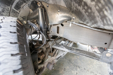 2004 American off-road classic 4x4  family turbo diesel truck underneath picture- axles, shock absorbers, yoke differential, muffler. High quality picture for download