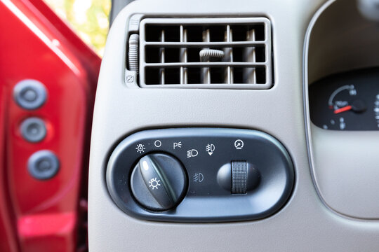 Close-up of dashboard vent and headlight control panel inside a 2004 American 4x4 family SUV showing light, fog, and cruise switches in beige cabin interior automotive design detail
