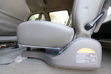 Rear two row beige leather bench seats, interior of an older 2004 American 4x4 family suv truck.   Shown in natural daylight, highlighting clean and well-preserved cabin details, speakers, armrests 