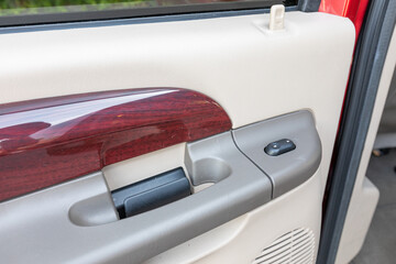 Interior photo of an older 2004 American 4x4 family suv truck highlighting clean and well-preserved beige color cabin details, speakers, door window power switches  