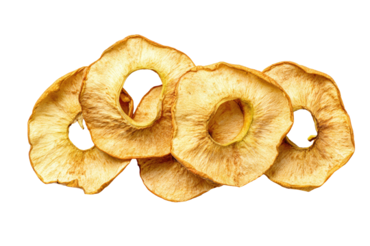 Close-up of dehydrated apple rings, golden brown with a central core, arranged on black background
