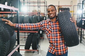 African american Man chooses winter car tires in the auto shop © Serhii