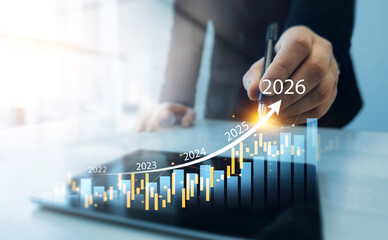 Businessman analyzing financial growth chart for 2026 year.Showing revenue increase, market trends, investment strategy, economic progress, success and future business development in 2026