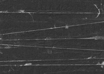 Fototapeta premium Black paper with fold line grunge background. Abstract rough surface backdrop. Distressed monochrome graphic element. For creative overlay design.