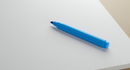 Blue marker pen on white surface with copy space for design and creativity