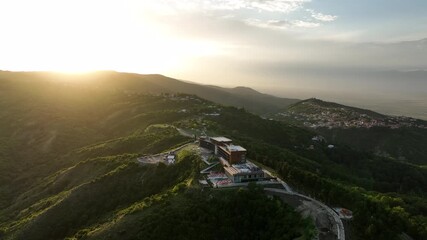 Sighnaghi, Georgia - July 15 2025: Aerial view of modern hilltop hotel Bodbe. Complex with Pool Terrace Overlooking Lush Green Valleys and Distant Horizon over Sighnaghi city