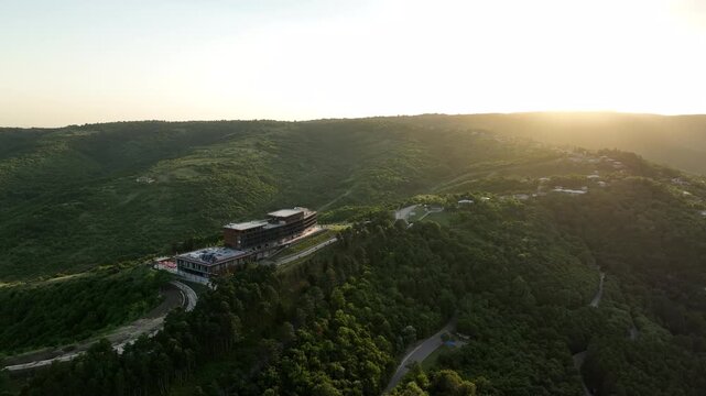 Sighnaghi, Georgia - July 15 2025: Aerial view of modern hilltop hotel Bodbe. Complex with Pool Terrace Overlooking Lush Green Valleys and Distant Horizon over Sighnaghi city