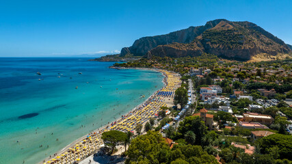 Fototapeta premium Aerial view of Mondello Beach, near Palermo, Sicily, Italy. It is a famous and beautiful tourist destination on the Mediterranean Sea. In background is Mount Pellegrino, overlooking the Tyrrhenian sea