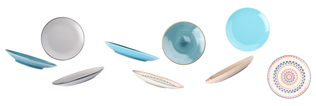 dynamic spread of colorful ceramic plates and serving bowls floating across the frame, showcasing various patterns and angles against a dark background photograph.