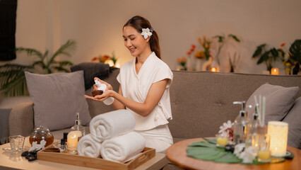 Adult Asian woman enjoys home spa selfcare ritual applying skincare product for beauty and wellness...