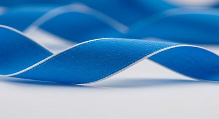 Abstract blue ribbon against white background with soft focus and copy space