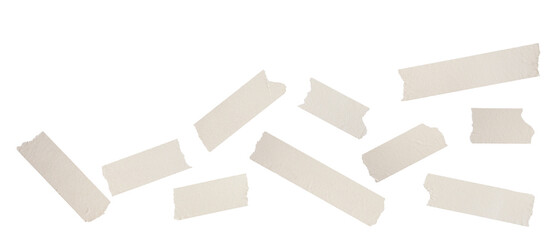 photograph of small, scattered pieces of beige masking tape arranged irregularly, showcasing ripped edges and realistic paper texture, isolated on black.