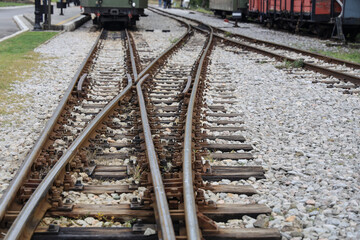 Intersecting Train Tracks and Switches narrow-gauge RAILWAY TRANSPORT - Turnouts on the railway siding in long perspective. Sargan Eight -- Mokra Gora, Serbia
