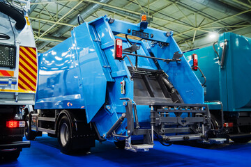 Rear view of a modern, bright blue garbage truck (refuse compactor) showcasing its robust mechanism and components. Essential for urban sanitation, environmental services, and sustainable waste manage