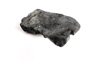lump of natural black charcoal isolated on a bright white background, representing pure grilling fuel, carbon material, and energy source for cooking, heating, and environmental or raw material concep