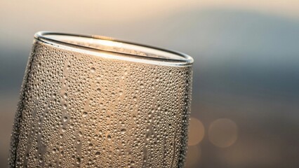 Iced Coffee with Cream Swirl—Macro shot of iced coffee with creamy swirl, condensation on glass, and soft bokeh background.