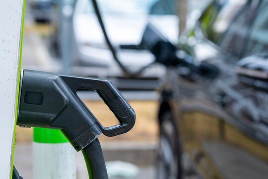 Close-up of electric car charging in Frankfurt showing modern plug design representing renewable mobility and sustainable energy transition in clean urban technology context