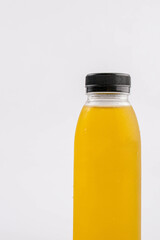 Fruit juice in a clear bottle on a white background