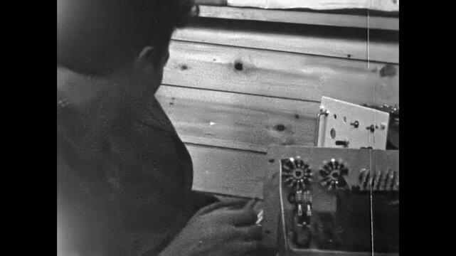 Close up, professional working men soldering electronics. Technicians solder electronic parts at workbench. Skilled hands, tools industrial repair in vintage workshop. Old film. Archival retro archive
