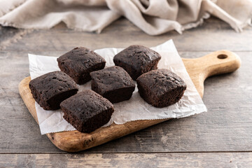 Homemade chocolate brownies with sugar powder on wooden table