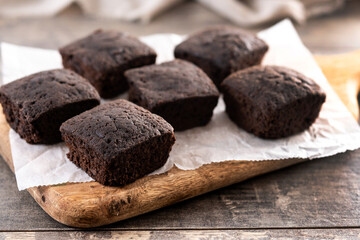 Homemade chocolate brownies with sugar powder on wooden table