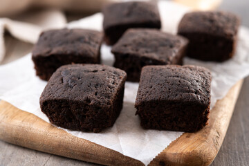 Homemade chocolate brownies with sugar powder on wooden table