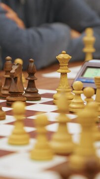 Player's hand making a move on the chessboard