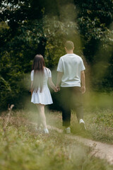 Fototapeta premium Young couple walking at nature at summer 