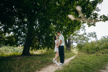 Fototapeta premium Young couple walking at nature at summer 