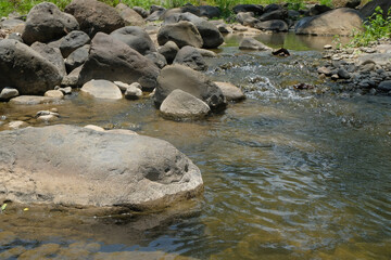Large rocks in a mountain river with clear water. Product placement concept. Climate and weather themes, ecology and environment. For graphic design, 3D rendering and banners