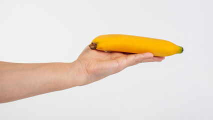 Yellow banana in hand on white background