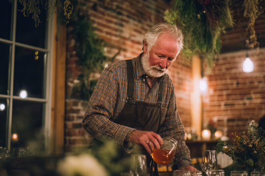 Elderly man pouring drink in cozy rustic bar

Description
An elderly man with white hair and a beard, wearing a plaid shirt and apron, pours a drink from a glass jar in a warmly lit, rustic-style bar 