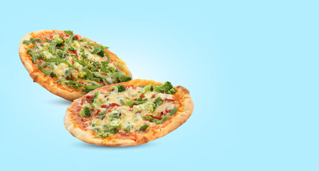 Different delicious pizzas in air on light blue background. Banner design with space for text