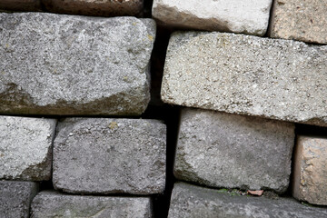 A close-up of a masonry of gray bricks stacked on top of each other