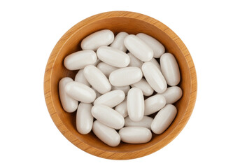 Isolated wood bowl of white capsules, health supplements, medicine, multivitamins, food additives