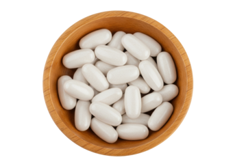 Isolated wood bowl of white capsules, health supplements, medicine, multivitamins, food additives