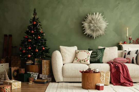 Festive living room with Christmas tree, wrapped presents, and soft textiles. Warm, modern space with classic red and green palette.