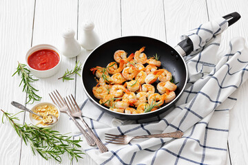 rosemary and garlic seared shrimps in a skillet