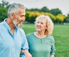 Portrait of a happy middle aged woman and  active middle aged white couple having fun walking...