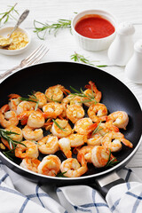 rosemary and garlic seared shrimps in a skillet