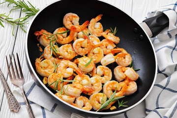 rosemary and garlic seared shrimps in a skillet