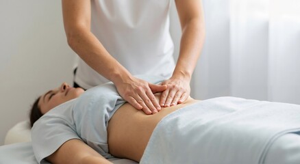 Woman stomach massage at spa. Therapist hands massaging belly on table. Female client abdomen treatment wellness concept.