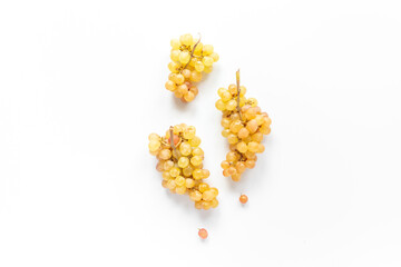 Many bunches of ripe yellow grapes on white background, top view