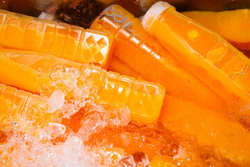 Orange juice bottles on ice