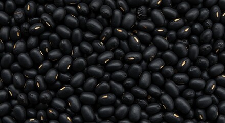 Close up of numerous black beans filling the frame on white background