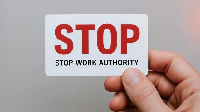 Stop safety prevention sign card held by hand authority encouraging worksite safety and accident prevention with hand sign for workplace safety