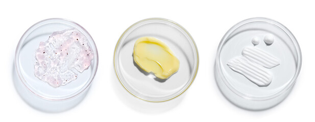 Petri dishes with cosmetic products on white background, top view