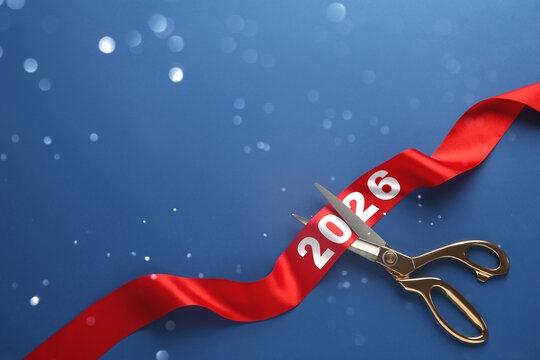 New 2026 Year poster design with scissors, red ribbon and bokeh lights