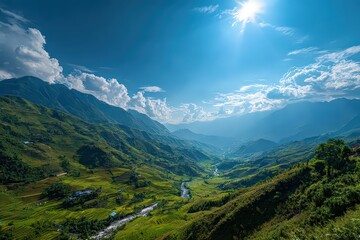 Lush Green Mountain Valley Landscape Under Bright Sunlight and Blue Sky with Cloud Formation