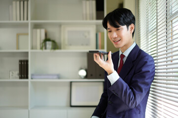 Businessperson using AI Agent virtual assistant with voice waveform interface. Concept of artificial intelligence support, voice bot, smart customer service, and virtual assistant automation.